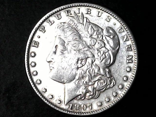 Silver Morgan Dollar Left-facing profile of Liberty wearing a Phrygian cap, with 'LIBERTY', "E PLURIBUS UNUM" and '1897' inscriptions on a black background with case
