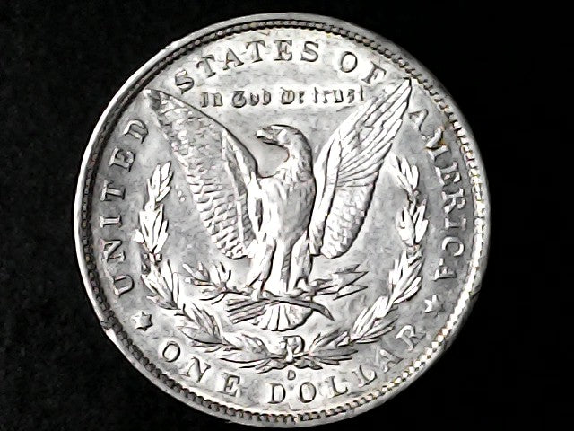 Silver Dollar with an eagle design, 'In God We Trust' and 'O' inscriptions on a black background 