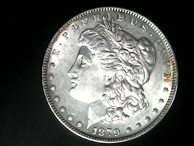 Silver Morgan Dollar Left-facing profile of Liberty wearing a Phrygian cap, with 'LIBERTY', "E PLURIBUS UNUM" and '1879' inscriptions on a black background with case