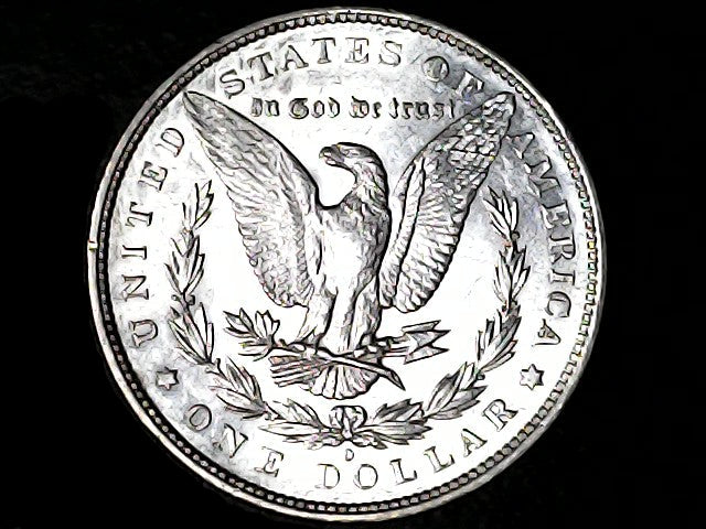 Silver Dollar with an eagle design, 'In God We Trust' and 'O' inscriptions on a black background 
