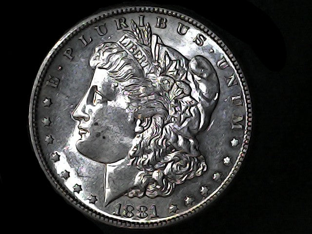 Silver Morgan Dollar Left-facing profile of Liberty wearing a Phrygian cap, with 'LIBERTY', "E PLURIBUS UNUM" and '1881' inscriptions on a black background with case