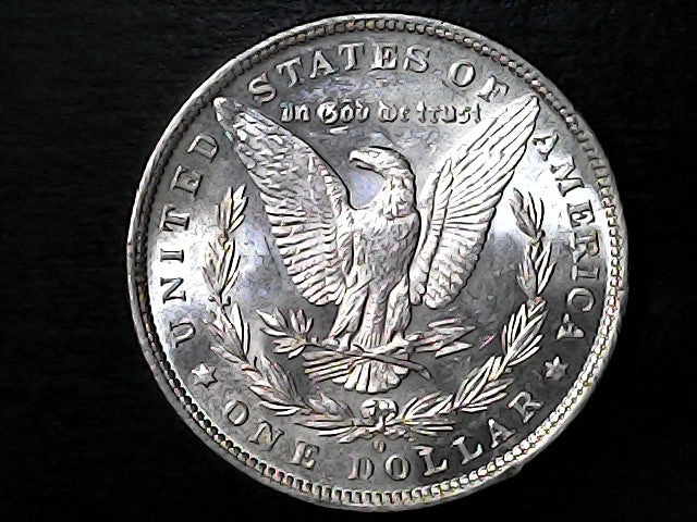 Silver Dollar with an eagle design, 'In God We Trust' and 'O' inscriptions on a black background 