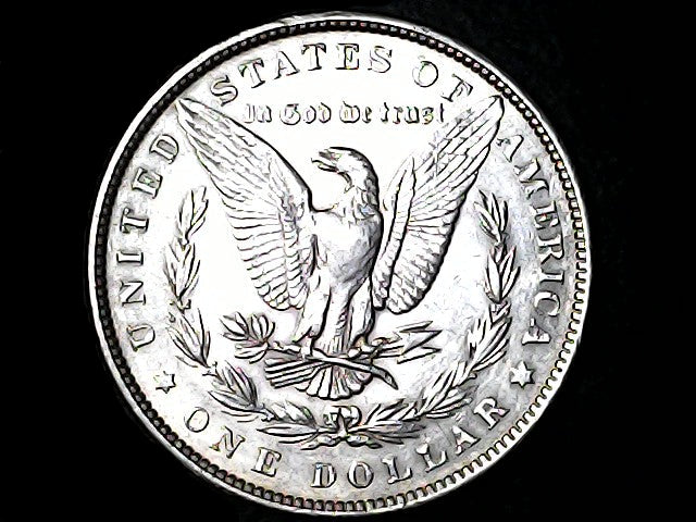 Silver Dollar with an eagle design and 'In God We Trust' inscription on a black background
