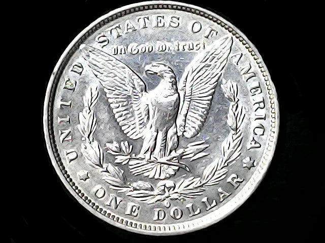 Silver Dollar with an eagle design, 'In God We Trust' and 'O' inscriptions on a black background 