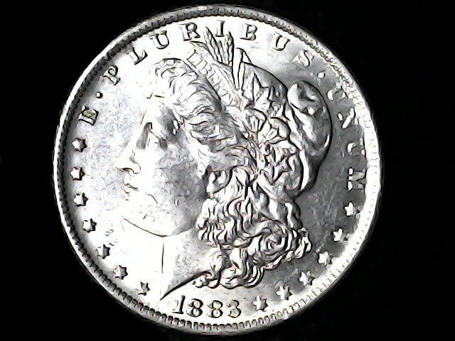 Silver Morgan Dollar Left-facing profile of Liberty wearing a Phrygian cap, with 'LIBERTY', "E PLURIBUS UNUM" and '11883' inscriptions on a black background with case