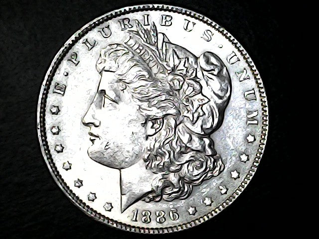 Silver Morgan dollar coin with a dark background