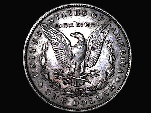 Silver dollar coin with an eagle design on a black background