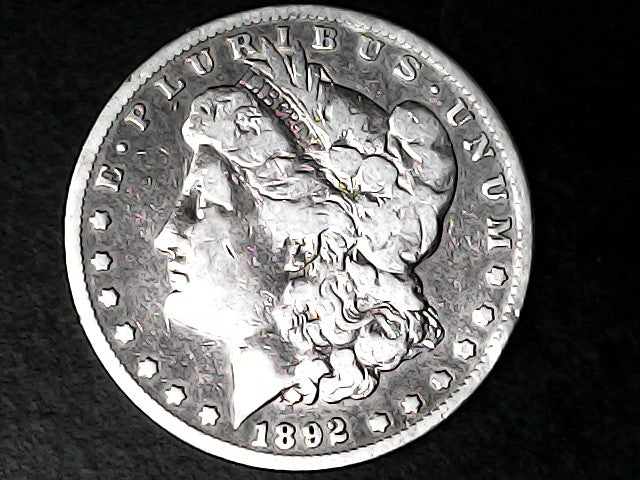 Silver Morgan Dollar Left-facing profile of Liberty wearing a Phrygian cap, with 'LIBERTY', "E PLURIBUS UNUM" and '1892' inscriptions on a black background with case