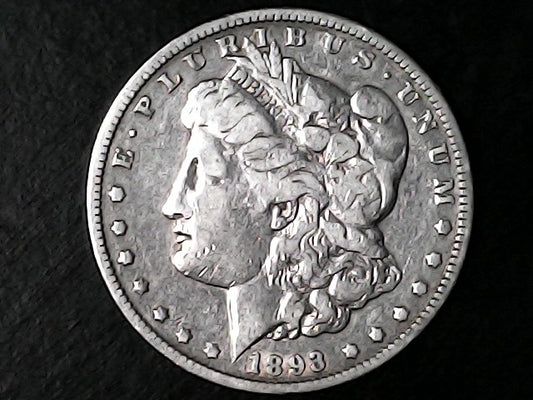 Silver Morgan Dollar Left-facing profile of Liberty wearing a Phrygian cap, with 'LIBERTY', "E PLURIBUS UNUM" and '1893' inscriptions on a black background with case