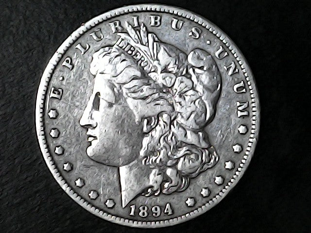 Silver Morgan dollar coin with 'E Pluribus Unum' and '1894' on a dark background
