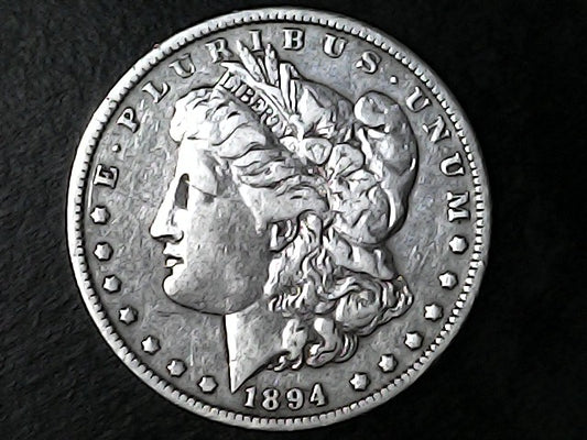 Silver Morgan dollar coin with 'E Pluribus Unum' and '1894' on a dark background