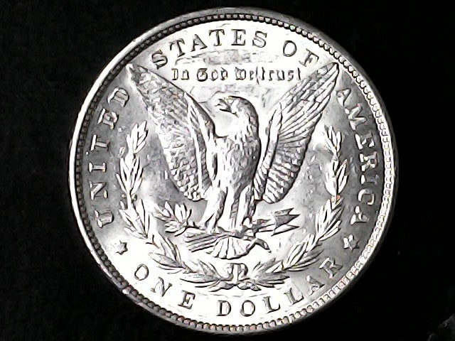 Silver Dollar with an eagle design and 'In God We Trust' inscription on a black background