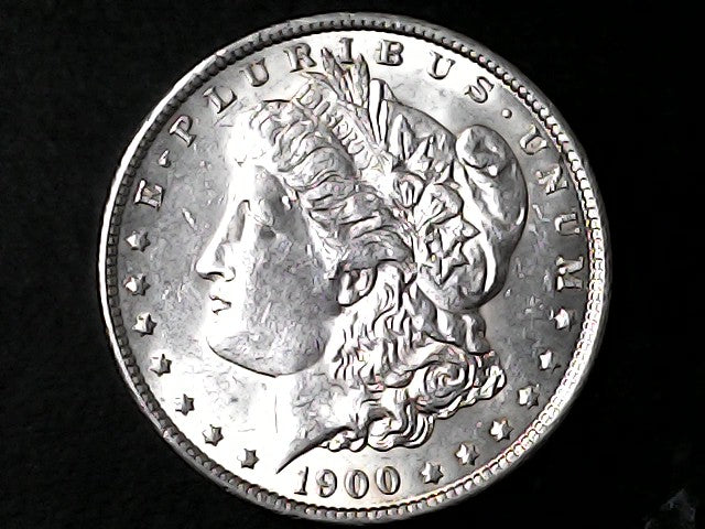 Silver Morgan Dollar Left-facing profile of Liberty wearing a Phrygian cap, with 'LIBERTY', "E PLURIBUS UNUM" and '1900' inscriptions on a black background with case