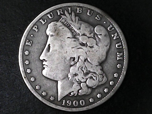 Silver Morgan Dollar Left-facing profile of Liberty wearing a Phrygian cap, with 'LIBERTY', "E PLURIBUS UNUM" and '1900' inscriptions on a black background with case