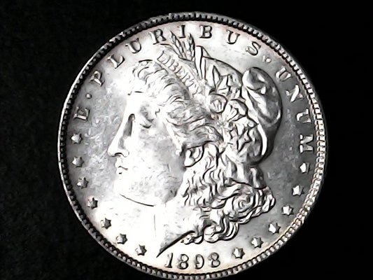 Silver Morgan Dollar Left-facing profile of Liberty wearing a Phrygian cap, with 'LIBERTY', "E PLURIBUS UNUM" and '1898' inscriptions on a black background with case