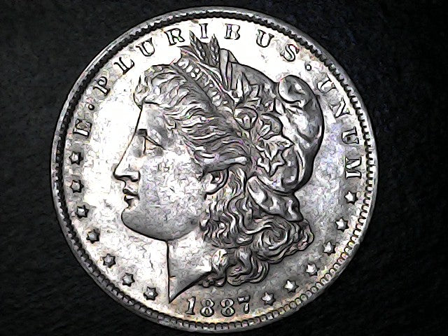 Silver Morgan dollar coin with a dark background