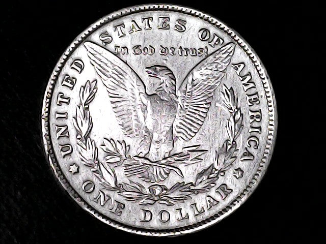 Silver Dollar with an eagle design and 'In God We Trust' inscription on a black background