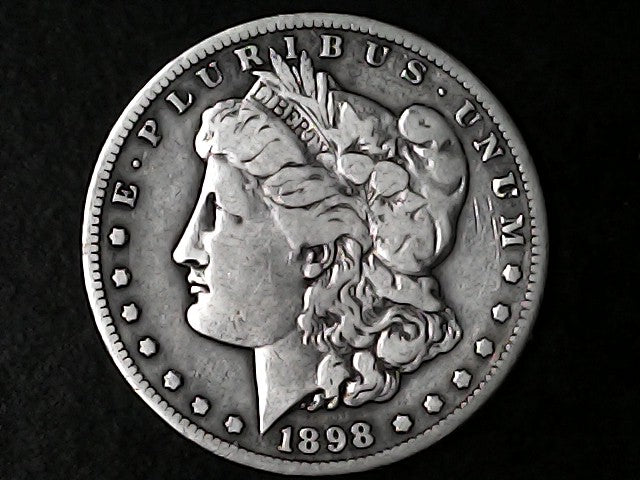 Silver Morgan Dollar Left-facing profile of Liberty wearing a Phrygian cap, with 'LIBERTY', "E PLURIBUS UNUM" and '1898' inscriptions on a black background with case