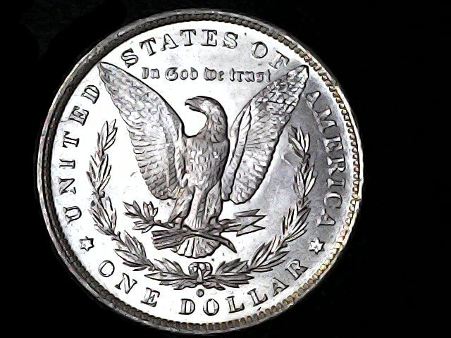 Silver Dollar with an eagle design, 'In God We Trust' and 'O' inscriptions on a black background 