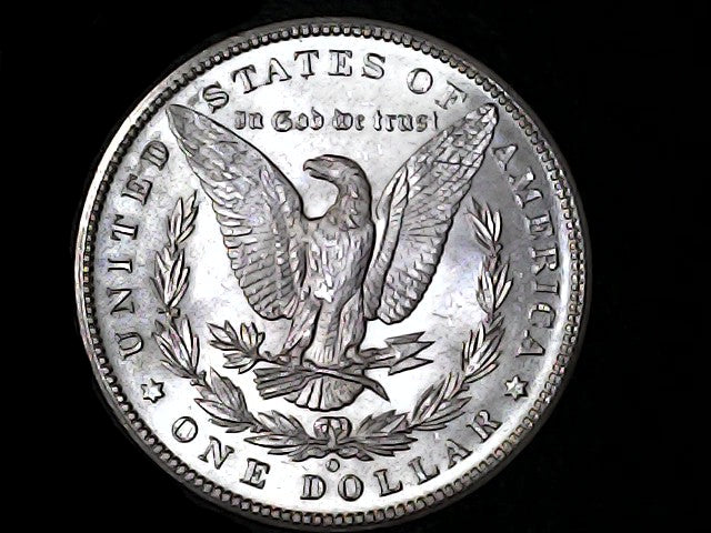 Silver Dollar with an eagle design, 'In God We Trust' and 'O' inscriptions on a black background 