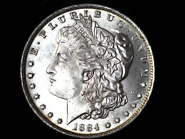 Silver Morgan Dollar Left-facing profile of Liberty wearing a Phrygian cap, with 'LIBERTY', "E PLURIBUS UNUM" and '1884' inscriptions on a black background with caseSilver Dollar with an eagle design, 'In God We Trust' and 'O' inscriptions on a black background 