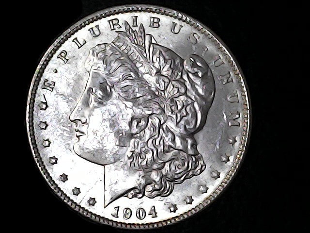 Silver Morgan Dollar Left-facing profile of Liberty wearing a Phrygian cap, with 'LIBERTY', "E PLURIBUS UNUM" and '1904' inscriptions on a black background with case