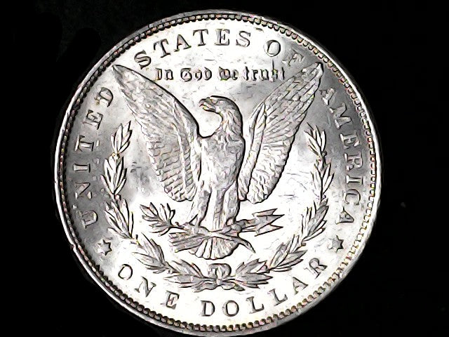 Silver Dollar with an eagle design and 'In God We Trust' inscription on a black background