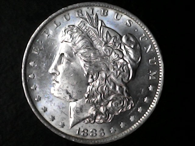 Silver Morgan Dollar Left-facing profile of Liberty wearing a Phrygian cap, with 'LIBERTY', "E PLURIBUS UNUM" and '1883' inscriptions on a black background with case 