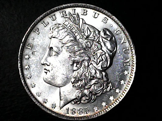 Silver coin with a profile of a head and inscriptions on a dark background