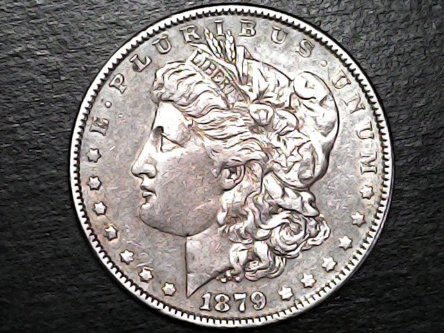 Silver Morgan Dollar Left-facing profile of Liberty wearing a Phrygian cap, with 'LIBERTY', "E PLURIBUS UNUM" and '1879' inscriptions on a black background with case