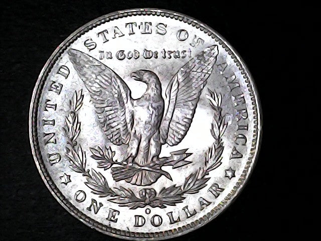 Silver Dollar with an eagle design, 'In God We Trust' and 'O' inscriptions on a black background 