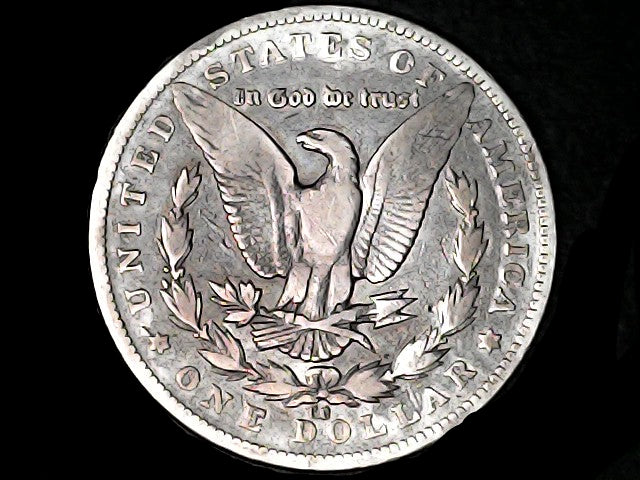 Silver Dollar with an eagle design, 'In God We Trust' and 'CC' inscriptions on a black background 