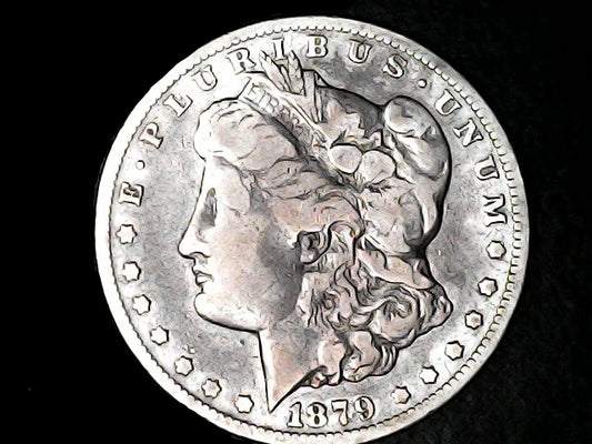 Silver Morgan Dollar Left-facing profile of Liberty wearing a Phrygian cap, with 'LIBERTY', "E PLURIBUS UNUM" and '1879' inscriptions on a black background with case