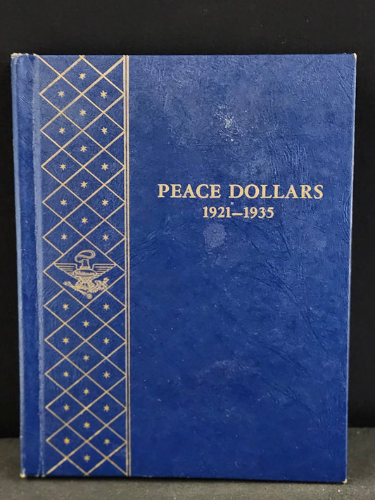 Blue album for Peace Dollars 1921-1935 on a dark background