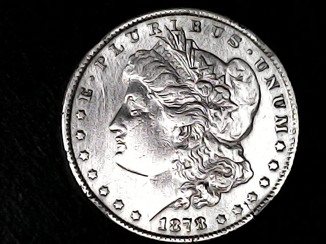 Silver Morgan Dollar Left-facing profile of Liberty wearing a Phrygian cap, with 'LIBERTY', "E PLURIBUS UNUM" and '1878' inscriptions on a black background with case
