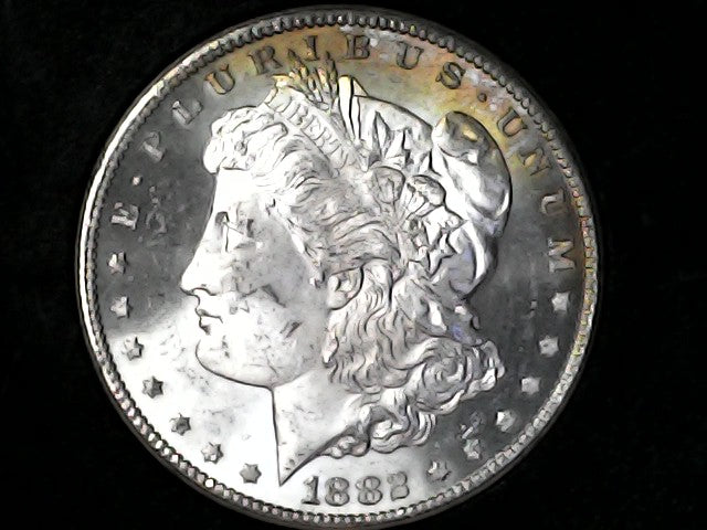 Silver Morgan dollar coin with a dark background