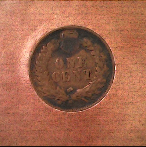 Close-up of a copper penny with 'ONE CENT' text 
