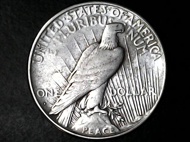 Silver Peace Dollar coin with an eagle design with 'S' inscription on a dark background