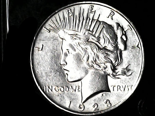 1923 Peace Dollar  with 'Liberty' and 'In God We Trust' inscriptions.