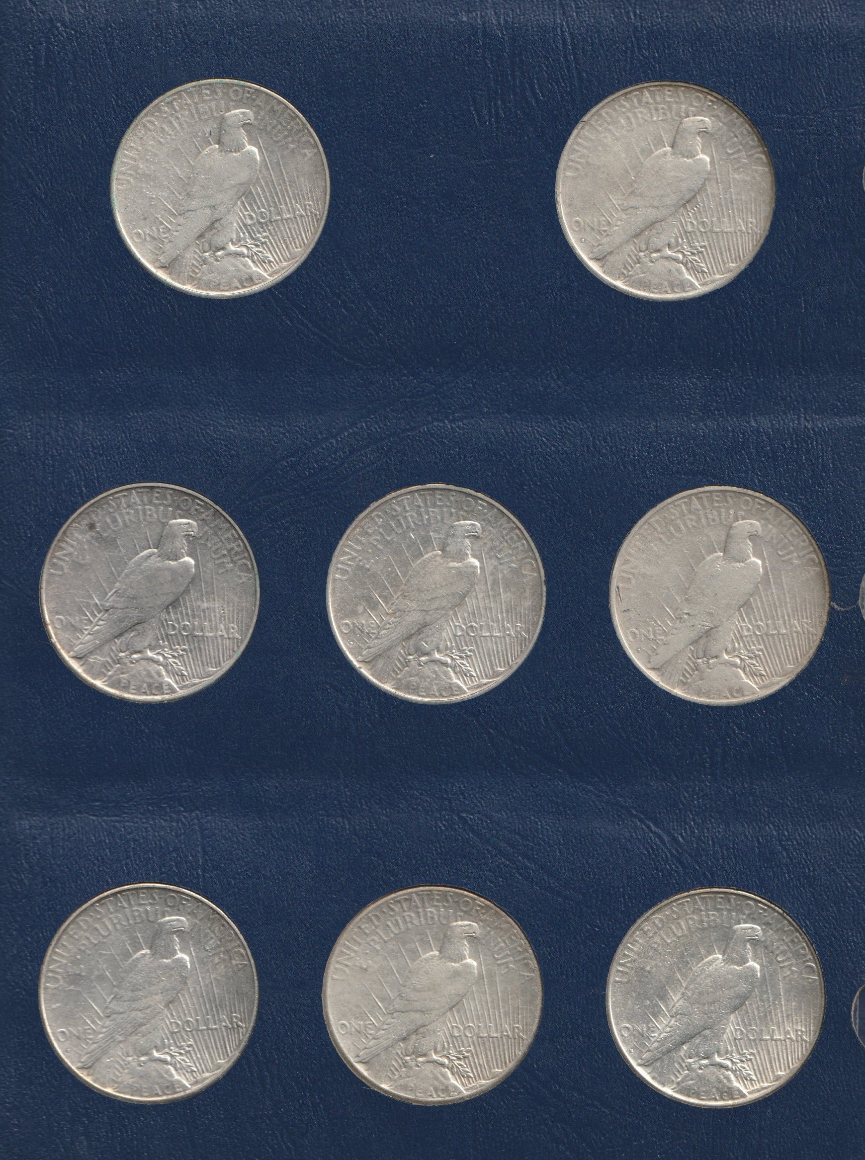 Set of silver coins with an eagle design on a blue background